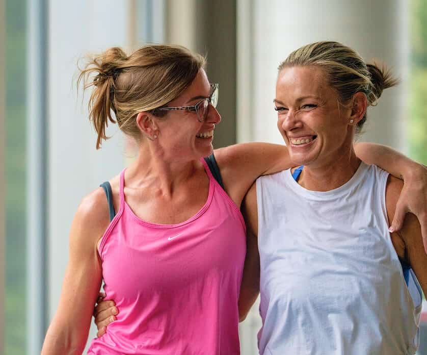 members of acac fitness & wellness supporting eachother during a group fitness class