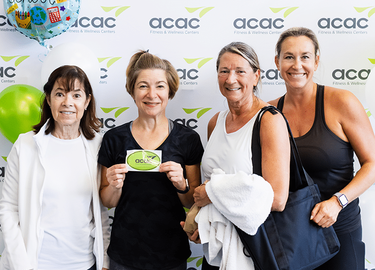 a group of acac fitness & wellness employees posing at a community event