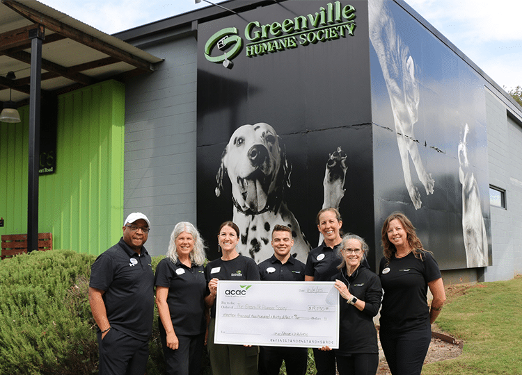 a group of acac fitness & wellness employees donating for a charitable cause